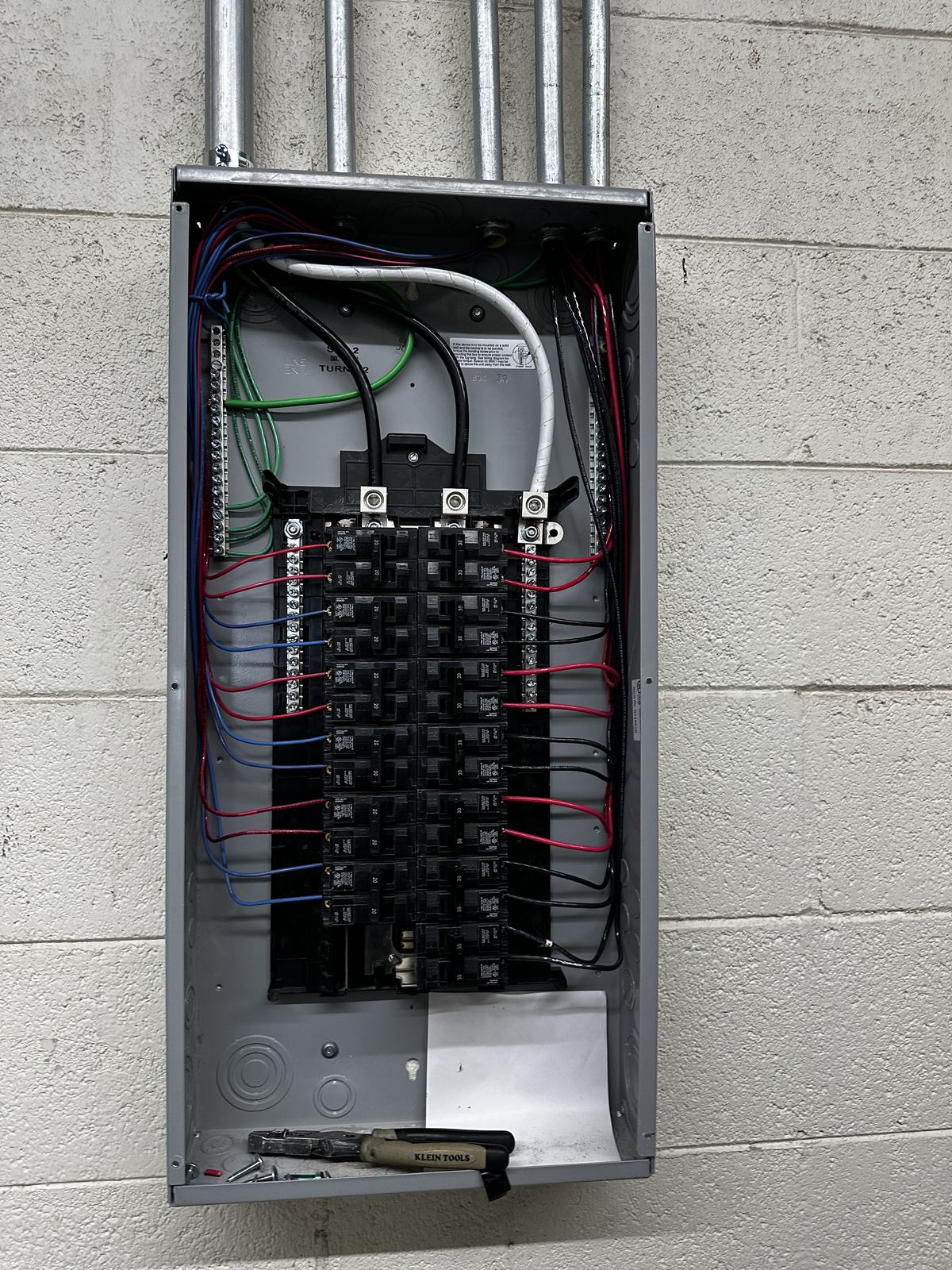 Electrical panel with new breakers, grounds and neutrals landed, and circuits labeled.